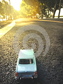 Toy car on the road nature background ,vintage filter