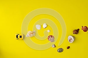 A toy car with shellfish on yellow background