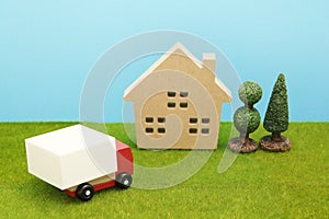 Toy car truck and house on green grass.