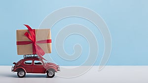 Toy car Volkswagen Beetle with gift on the top on blue background