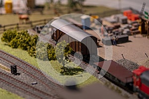 Toy cars of the children\'s railway stand on the rails, a marshalling yard.