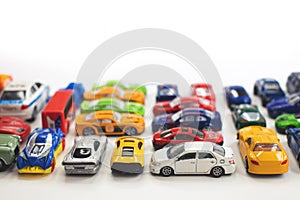 Toy cars of different colors arranged on a white background