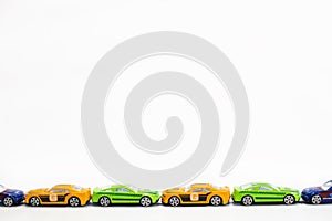 Toy cars of different colors arranged on a white background