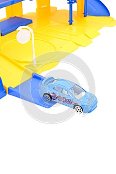 Toy cars and racing track on white background