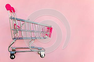 Toy cart on pastel pink background