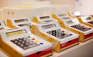 Toy cash registers for kids on display in store.