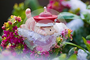 Toy cat lie prone on ice of flowers photo