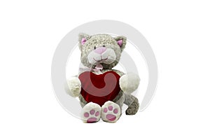 Toy cat sits holding a heart on white background.