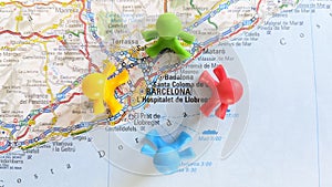 Toy children playing in a circle on a map of Barcelona