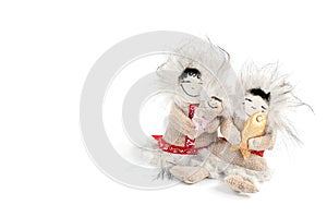 Toy Chukchi with fish and baby in his arms