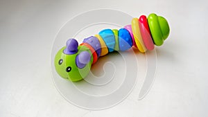 Toy colored caterpillar on a light background