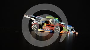 Toy constructor racing car spinning in the dark