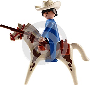 Toy cowboy on horse isolated