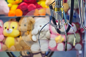 Toy crane vending machine, claw game or cabinet to catch the toys. Shopping, holiday activity, game of chance. Selective focus on