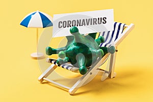 Toy deck chair and tag with the inscription on a yellow background. Concept on beach closure due to COVID-19 photo
