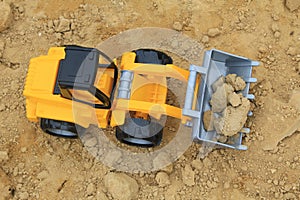 Toy digging machine on the sand