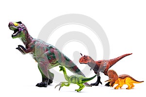 Toy dinosaurs on white, object photo