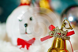 A toy dog in Santa hat and Christmas gifts on the background of coniferous branches