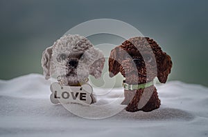 Toy dog - a symbol of the new year under the snow against the background of fir branches. Toy's dog as a symbol of 2018 New Year