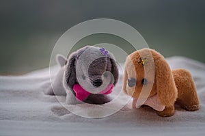 Toy dog - a symbol of the new year under the snow against the background of fir branches. Toy's dog as a symbol of 2018 New Year