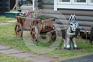 A toy donkey with wooden cart