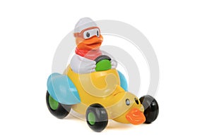 Toy duck driving duck-car on white background