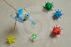 Toy of an earth fighting with a sword against viruses