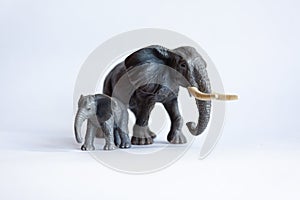 Toy elephant with a cub on a white background