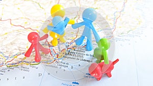 A toy family visiting Barcelona standing on a map of the city