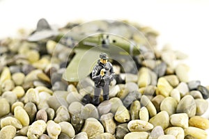 Toy figure of soldier on stones on blurred airplane background. Military war concept.