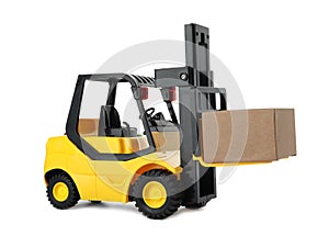 Toy forklift with box isolated. Logistics and wholesale concept