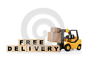 Toy forklift and cubes with words FREE DELIVERY isolated. Logistics and wholesale concept