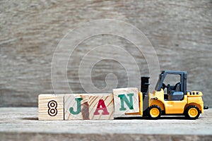 Toy forklift hold block N to word 8jan on wood background Concept for calendar date in 8 month January