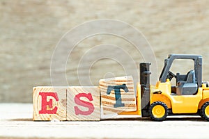 Toy forklift hold block t to complete word EST abbreviation of established, estimated, eastern time zone, expressed