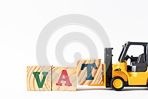 Toy forklift hold letter block T to complete word VAT Abberviation of Value added tax on white background
