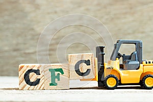 Toy forklift hold block to complete word Alphabet letter in word CFC abbreviation of Chlorofluorocarbon on wood