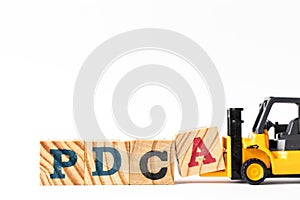 Toy forklift hold letter block a to complete word PDCA Plan, Do, Check, Act on white background