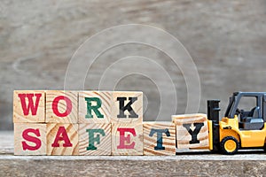 Toy forklift hold letter block Y to complete word work safety