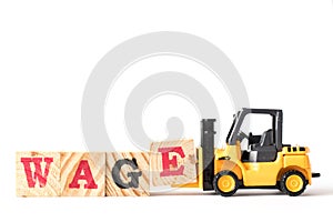 Toy forklift hold wood block e in word wage on white background