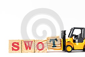 Toy forklift hold wood block t to complete word swot abbreviation of strength, weakness, opportunities, threats on white