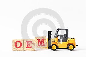 Toy forklift hold wood letter block M to complete word OEM Abbbreviation of Original Equipment Manufacturer on white background