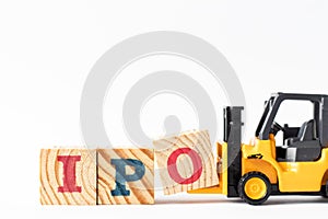 Toy forklift hold wood block O to complete word IPO Abbreviation of Initial Public Offering on white background