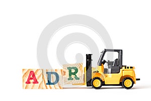 Toy forklift hold wood letter block A to word ADR Abbreviation of Adverse drug reaction on white background