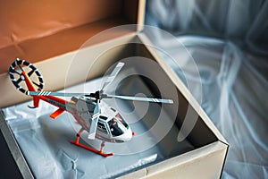 toy helicopter with rotor blades in oversized gift box