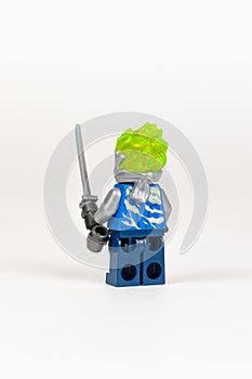 Toy hero Jay in a blue kimono with a sword from a set of lego ninjago on a white background. close-up