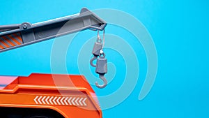 Toy hooks tow truck on a blue background with room for text. Children`s car