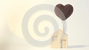 Toy house on a clean background and twinkling lights. Wooden house with a balloon. Dream House