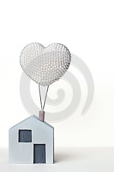 Toy house on a clean background. Wooden house with a balloon. Dream House