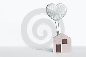 Toy house on a clean background. Wooden house with a balloon. Dream House