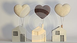 Toy houses on a clean background and a sunset effect. Wooden house with a balloon. Dream House